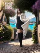 Ivory mink fur coat worn over a black dress, long sleeves