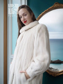 Ivory mink fur coat close-up: plush shoulder wrap and shawl collar