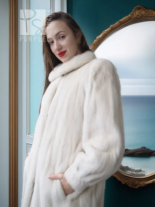 Ivory mink fur coat close-up: plush shoulder wrap and shawl collar