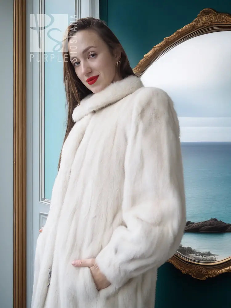 Ivory mink fur coat close-up: plush shoulder wrap and shawl collar