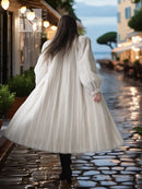 Back view of an ivory mink fur coat with wide skirt silhouette and long sleeves