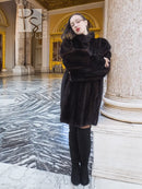 Vintage mink swing coat with high collar, long sleeves, dark fur texture, front button.