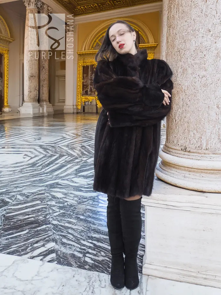 Vintage mink swing coat with high collar, long sleeves, dark fur texture, front button.