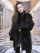 Vintage mink swing coat with high collar, long sleeves, dark fur texture, front button.