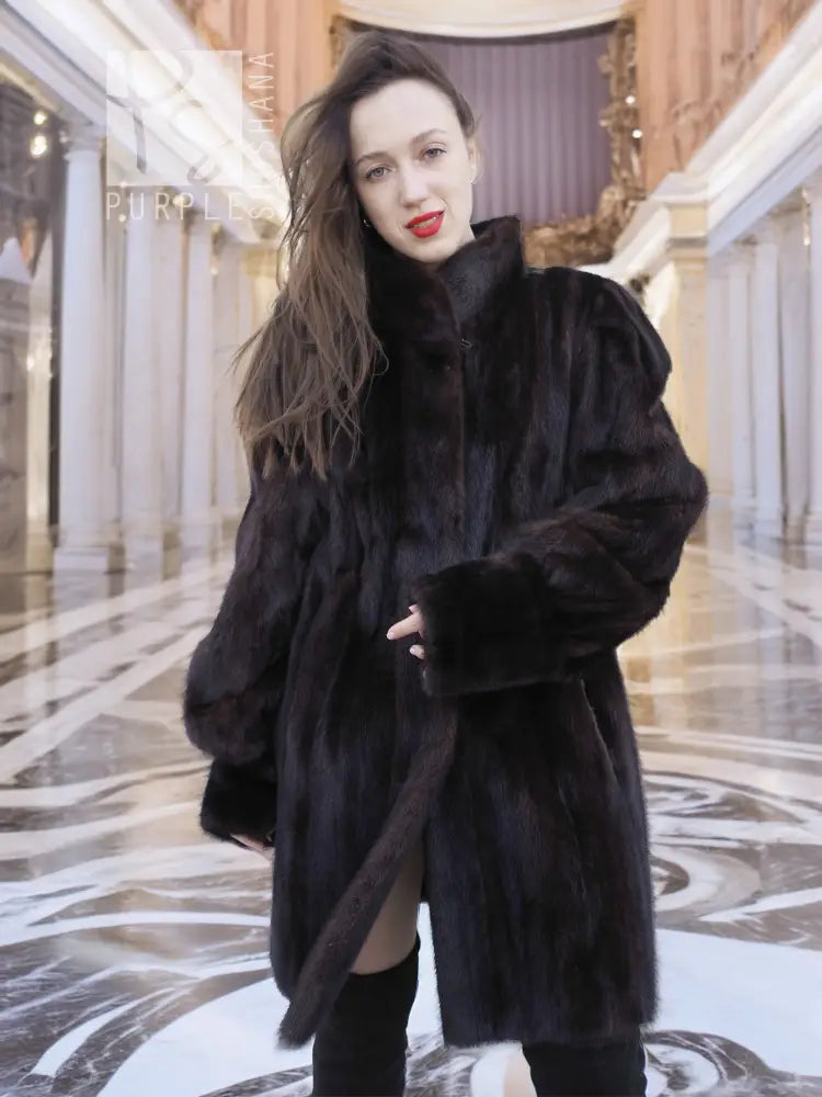 Vintage mink swing coat with high collar, long sleeves, dark fur texture, front button.