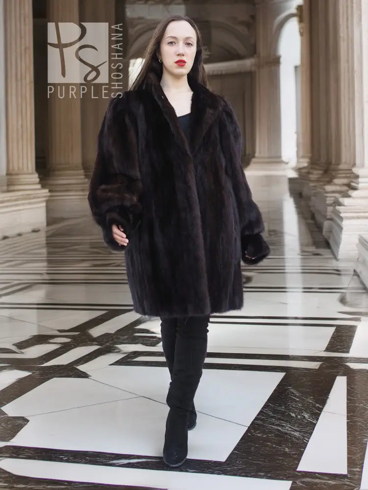 Vintage mink swing coat with stand collar, long sleeves, dark fur, side slit hem.