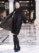 Vintage mink swing coat, dark fur, flowing swing hem, standing back three-quarter view