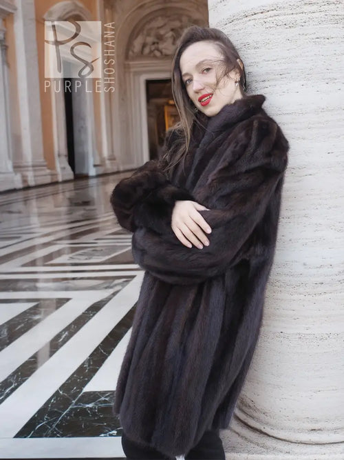 Dark vintage mink swing coat with high collar and long sleeves, front button detail.