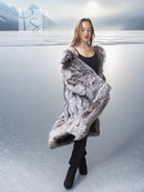 Gray faux fur wrap or stole with long sleeves, worn over a black mini dress.