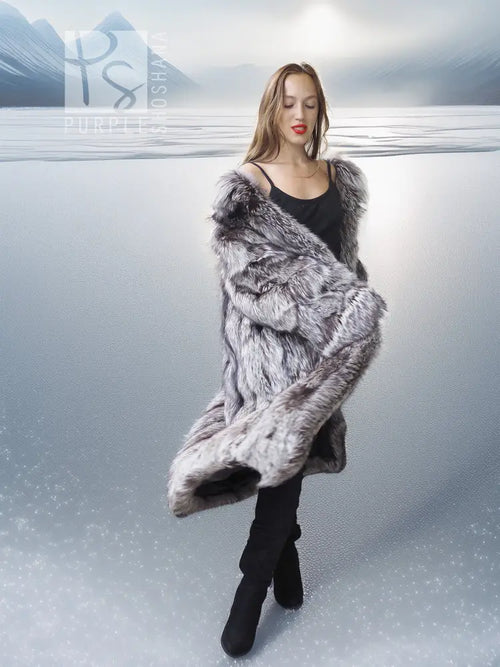 Gray faux fur wrap or stole with long sleeves, worn over a black mini dress.