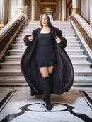 Dark mink coat worn open, oversized collar, long sleeves, full length.