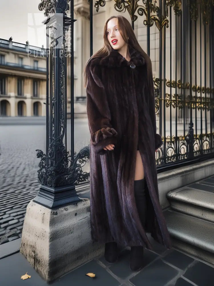 Full-length dark mink coat with standing collar and side slits.