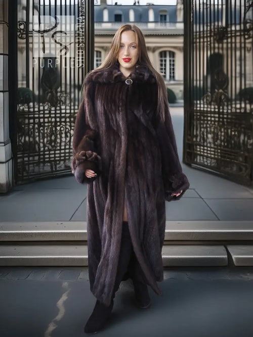 Dark mink coat with buttoned front, standing collar, and side slits.
