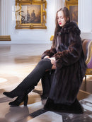 Dark mink fur coat with high collar and relaxed fit, long sleeves, hem slit.