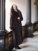 Dark mink fur coat with buttoned front and plush cuffs, long fitted silhouette