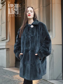 Sheared muskrat fur coat in dark teal, front view with stand collar and snap closure