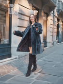 Deep teal sheared muskrat fur coat with round front clasp and long sleeves, standing view