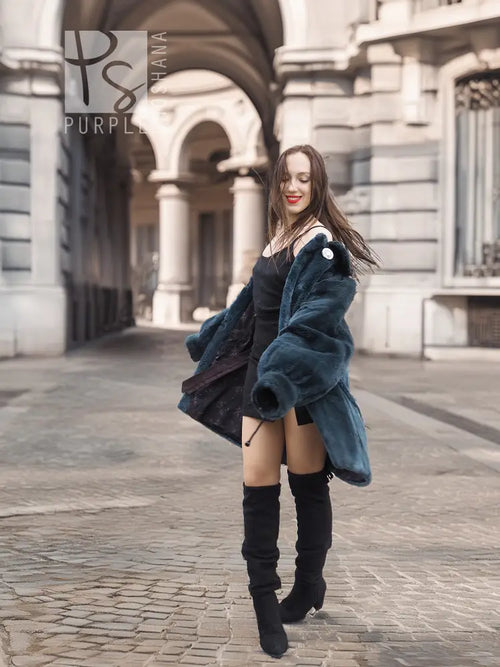 Sheared muskrat fur coat in dark teal, side/back view with stand collar and snap front