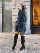 Sheared muskrat fur coat in dark teal, side/back view with snap closure and long sleeves