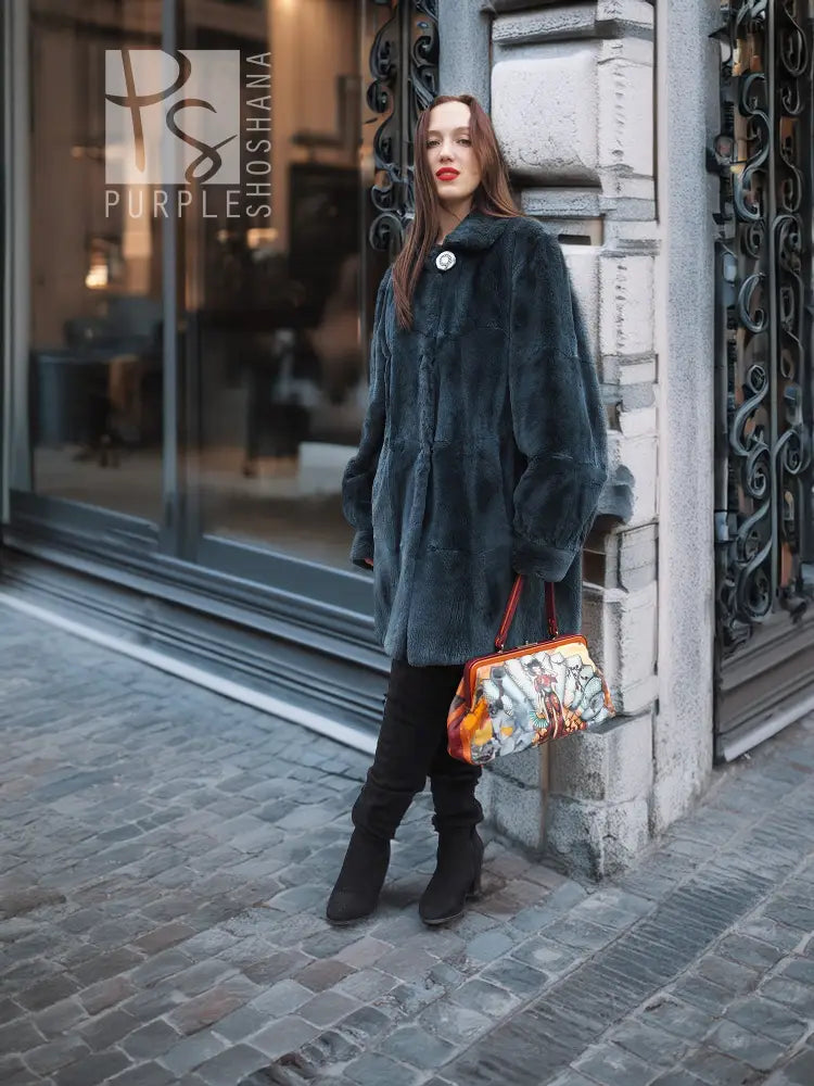 Deep teal muskrat fur coat with front button closure and long sleeves, standing front view