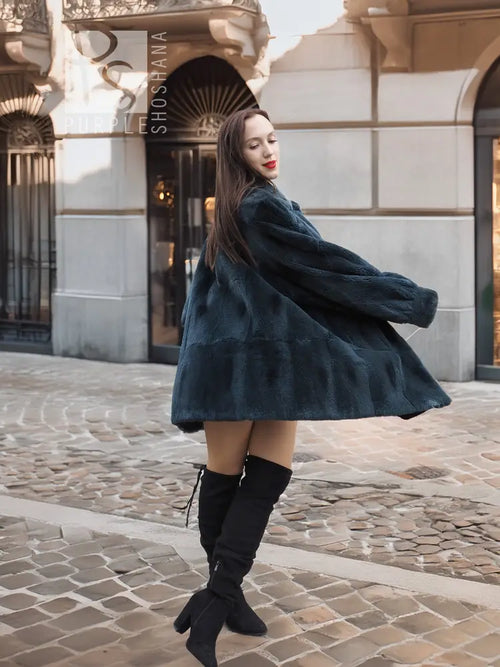 Deep teal muskrat fur coat, wide flared hem, front open, back view