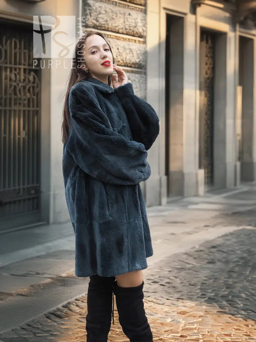Sheared muskrat fur coat in dark teal with stand collar and snap closure, front view