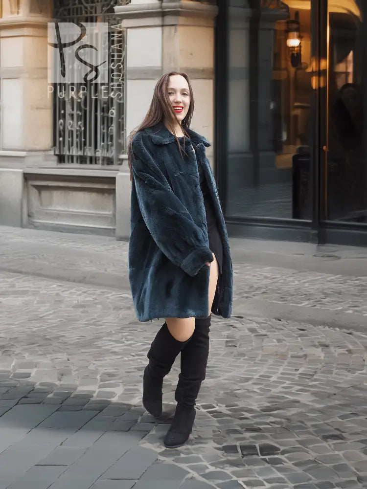 Deep teal muskrat fur coat with front button closure and long sleeves, relaxed front view