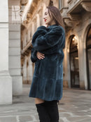 Sheared muskrat fur coat in dark teal, rear view with stand collar and snap front