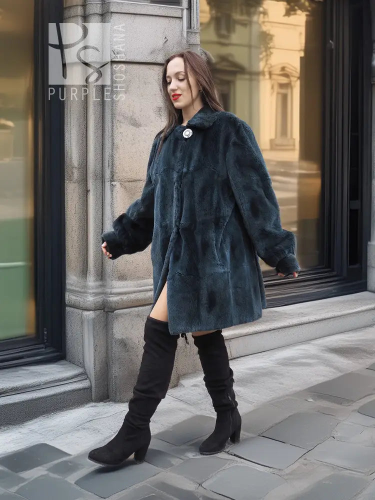 Sheared muskrat fur coat in dark teal, three-quarter view with snap front and long sleeves