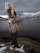 Brown raccoon fur jacket with oversized collar, cropped view from the side
