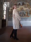 Mid-length sheared beaver coat in light honey-tan, long sleeves, button-front, side pockets