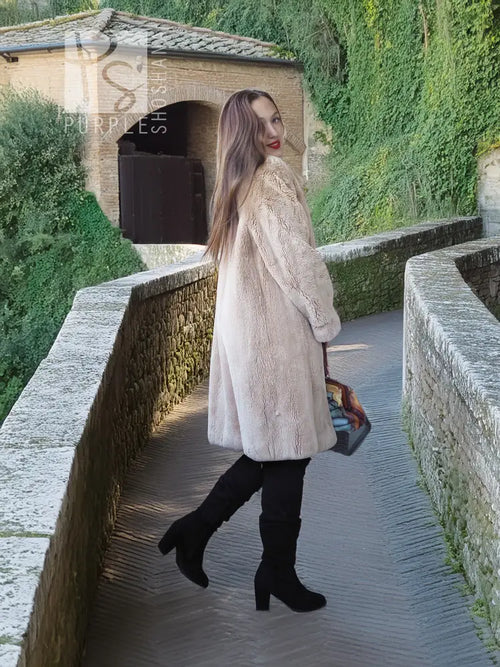 Sheared beaver coat in light honey, side view with open front and long hem