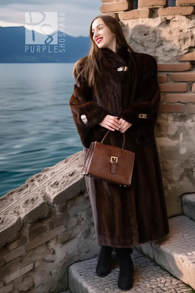 Dark brown mink coat with front buttons and plush fur cuffs, side view