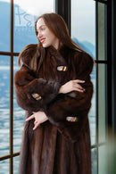 Brown mink coat close-up with plush fur, wide collar, and rectangular cuff details
