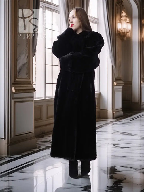 Long black fur coat with high collar and full skirt silhouette