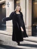 Black sheared beaver fur coat with stand collar; angled full-body pose, long open front.