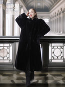 Black sheared beaver fur coat with stand collar, long open front; full-body view.
