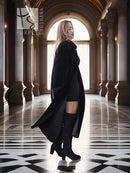 Black sheared beaver fur coat with stand collar; side profile, long flared hem.