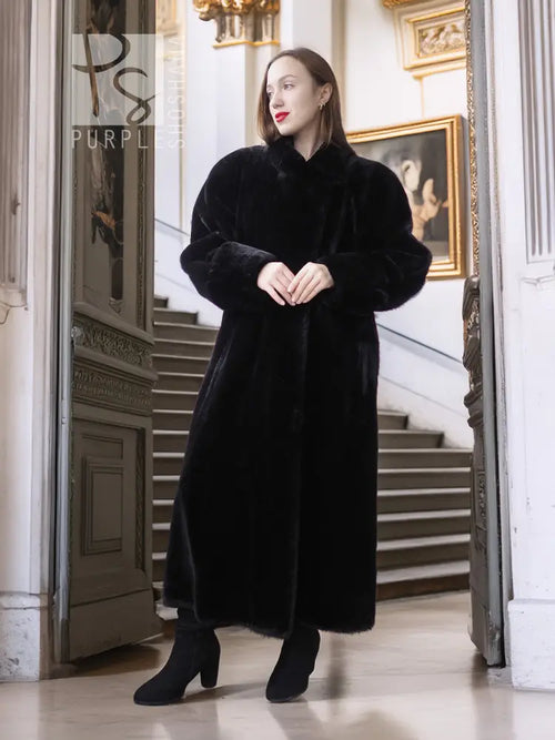 Black long fur coat with plush texture and buttoned front