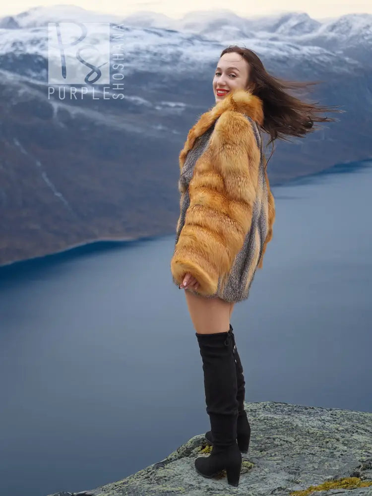 Two-tone fur coat with golden fox-style sleeves and gray body, worn with black boots