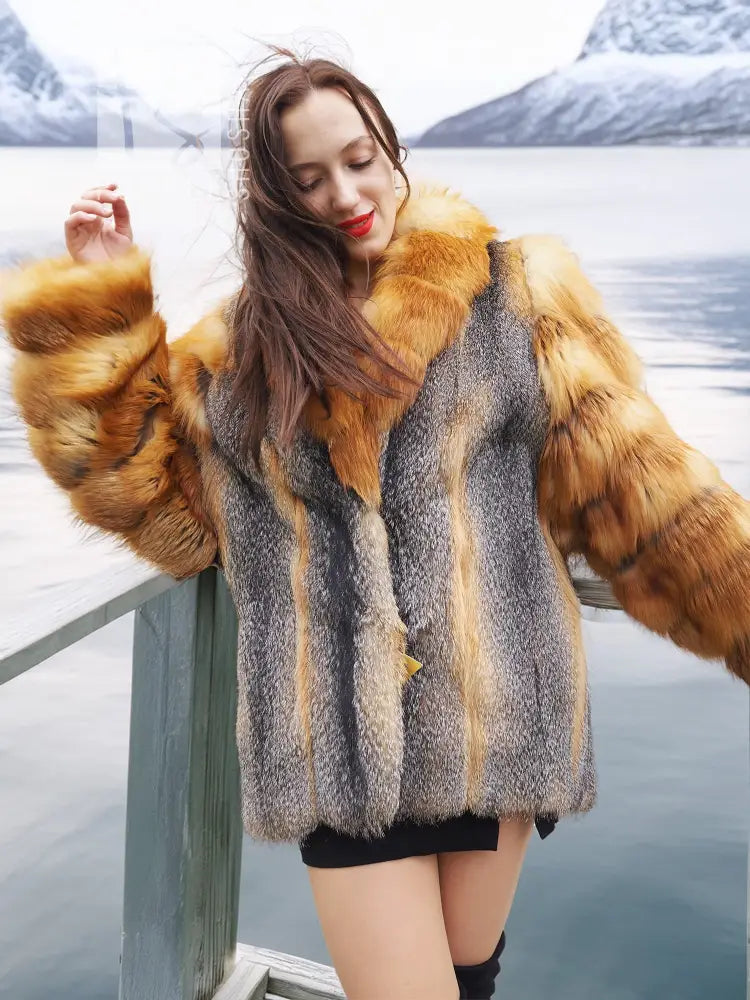 Fur coat with gray textured fabric and orange fox fur cuffs, close-up shoulder view