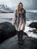 Gray and silver fur hooded coat, long sleeves, worn over dark knee-high boots