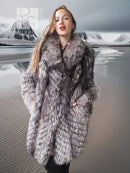 Silver fox faux fur hooded coat close-up, textured gray fur and wide collar.