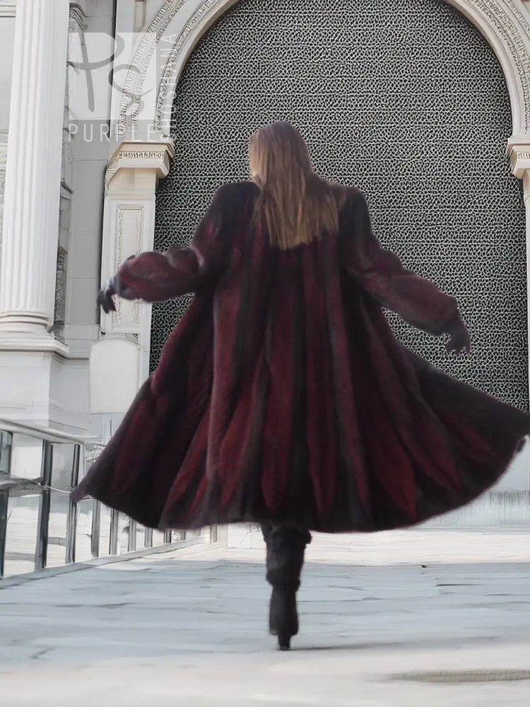 Back view hooded mink fur coat, black and burgundy tones, flared hem