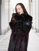 Two-tone mink fur coat, dark with red accents, belted waist and fur cuffs, close-up