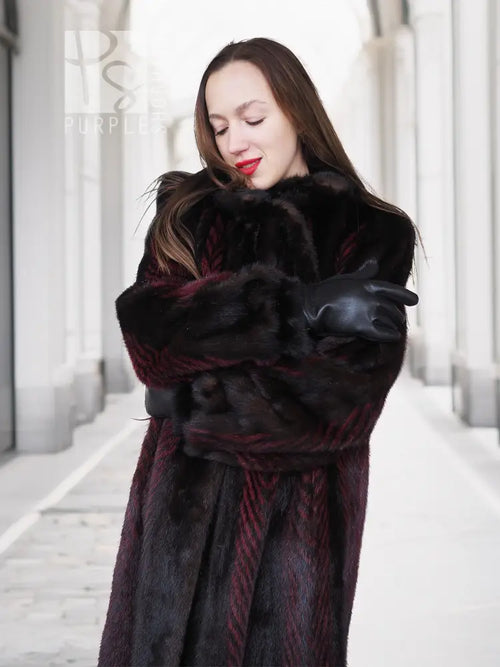 Two-tone mink fur coat, dark with red accents, belted waist and fur cuffs, close-up