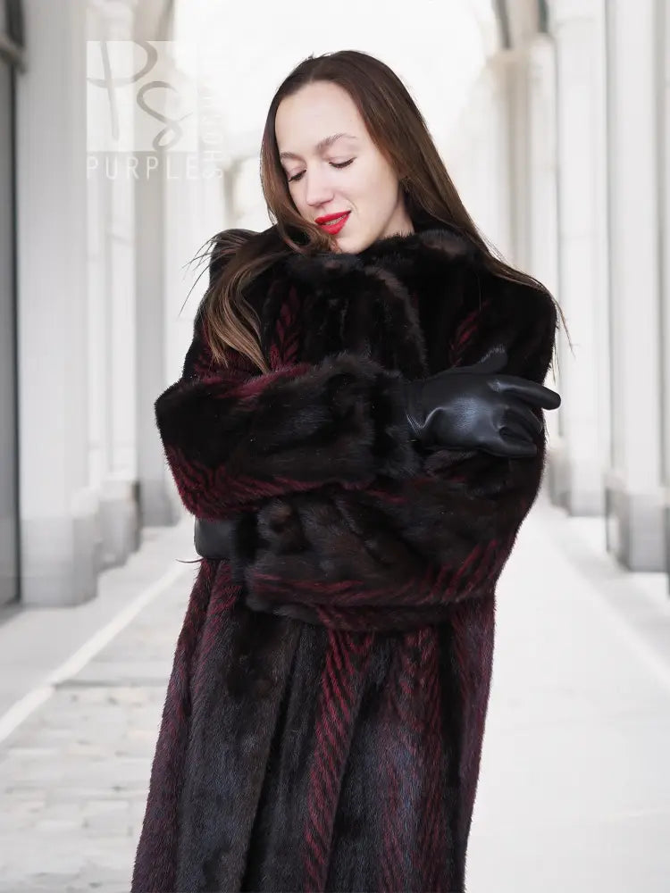 Two-tone mink fur coat, dark with red accents, belted waist and fur cuffs, close-up