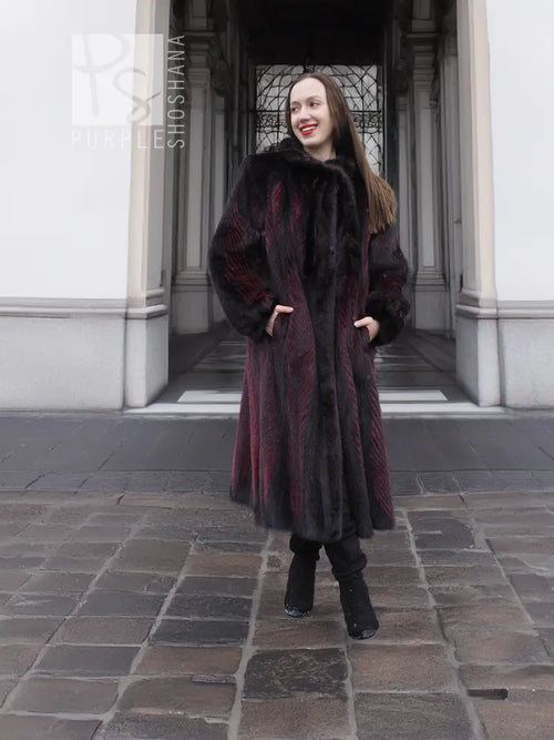 Full-length hooded mink fur coat, black with burgundy vertical panels, long sleeves