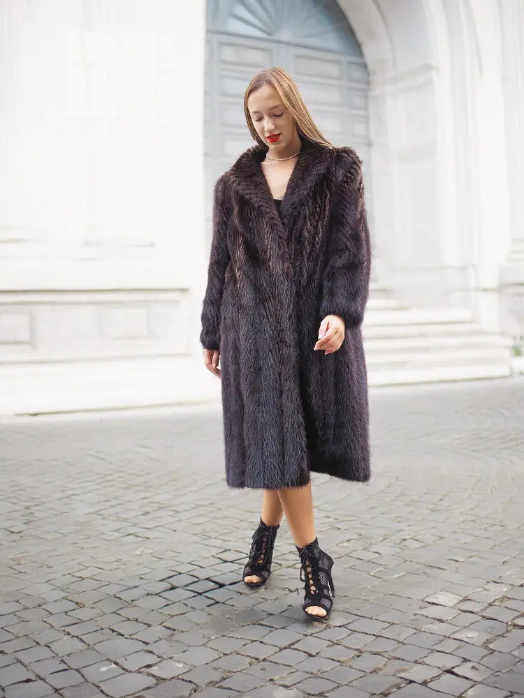 Two-tone muskrat fur coat in dark tone with textured herringbone finish, mid-length