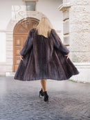 Two-tone muskrat fur coat, dark with light collar and herringbone texture, mid-length